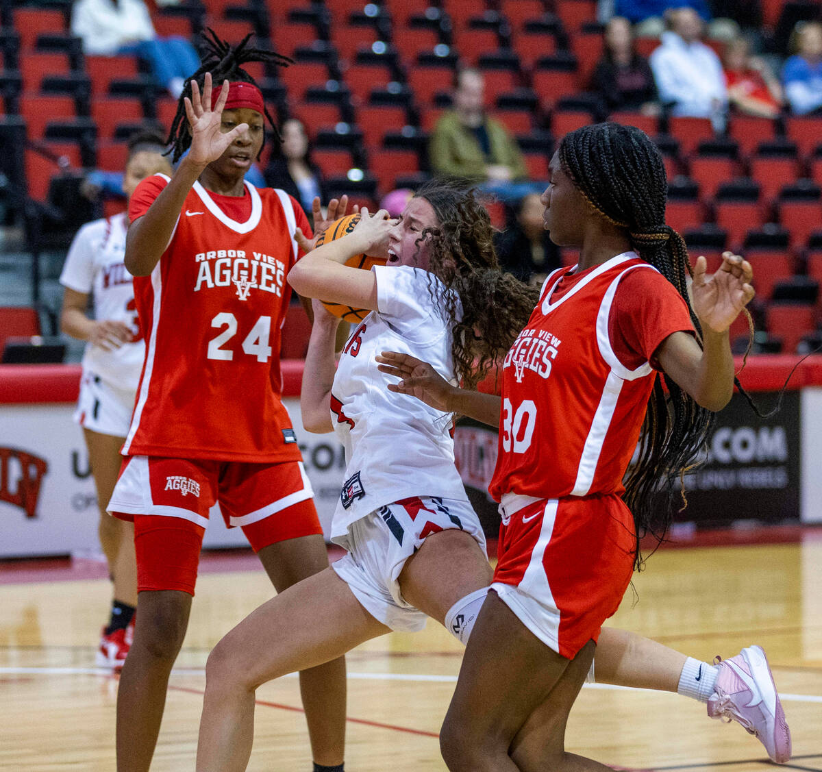 Las Vegas' Layla Faught (1) drives the lane with contact against Arbor View's Sanai Branch (24) ...