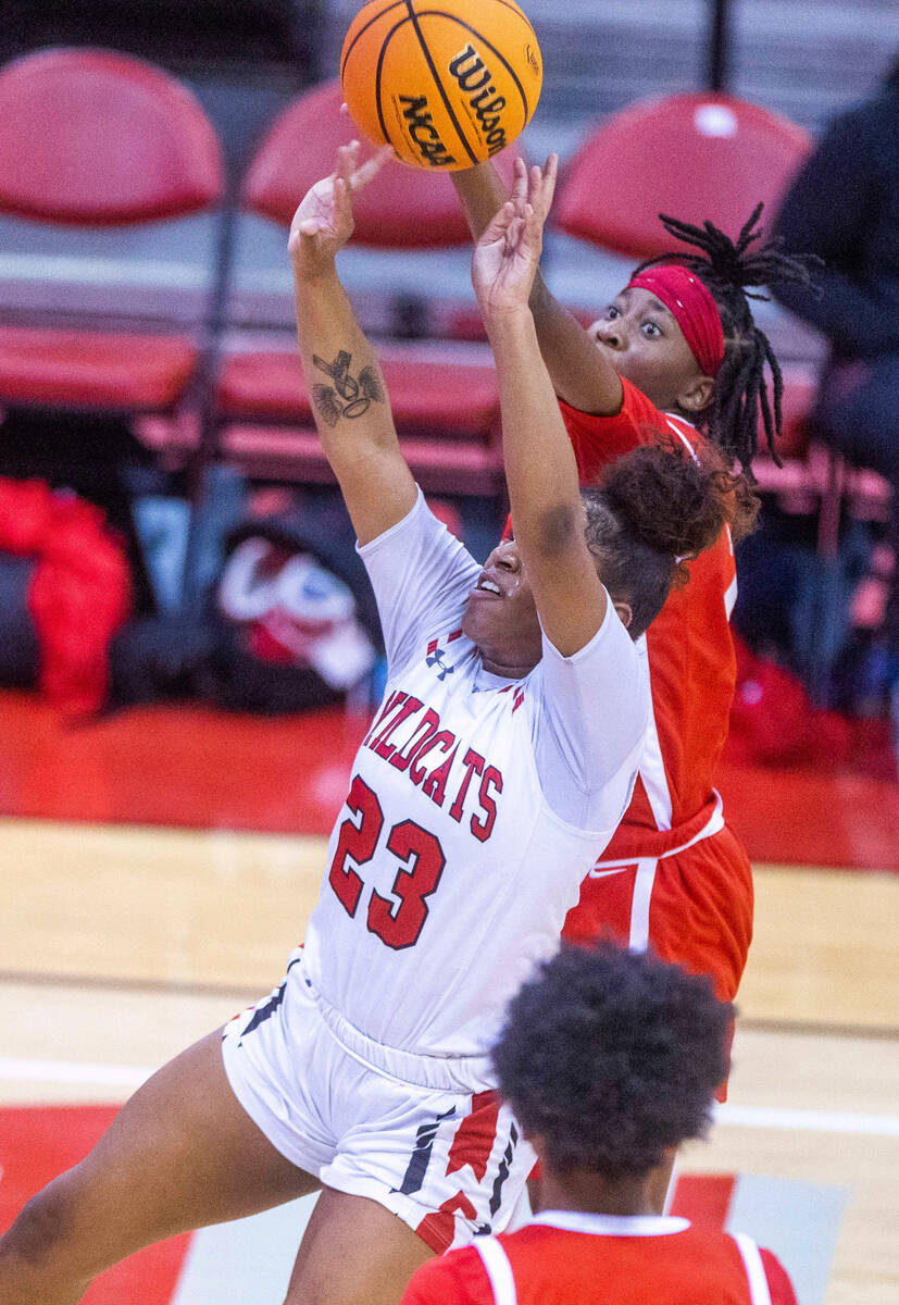 Las Vegas' Kayla Terry (23) has a shot attempt blocked from behind by Arbor View's Sanai Branch ...