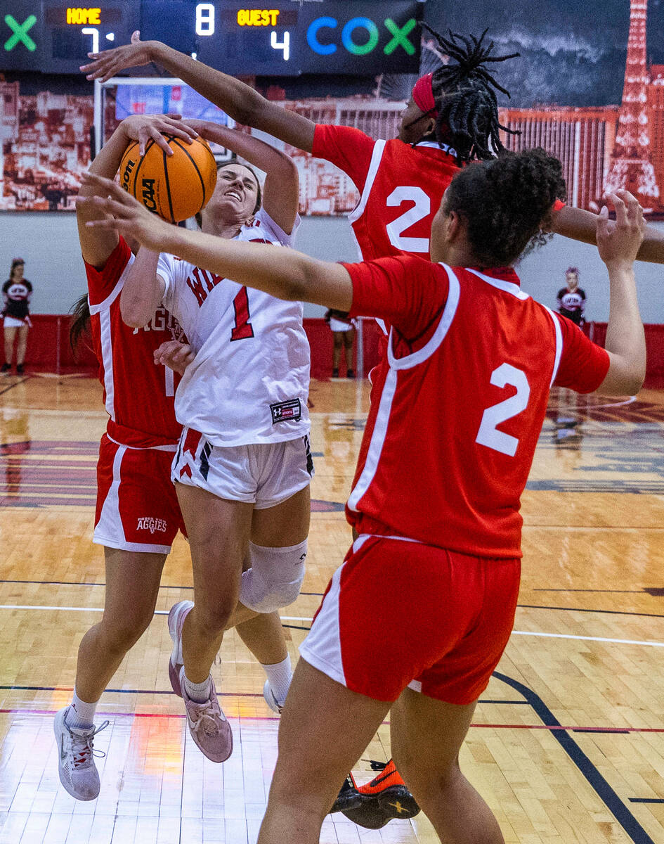 Las Vegas' Layla Faught (1) is fouled while driving the lane by Arbor View's Arianna Vera (11) ...