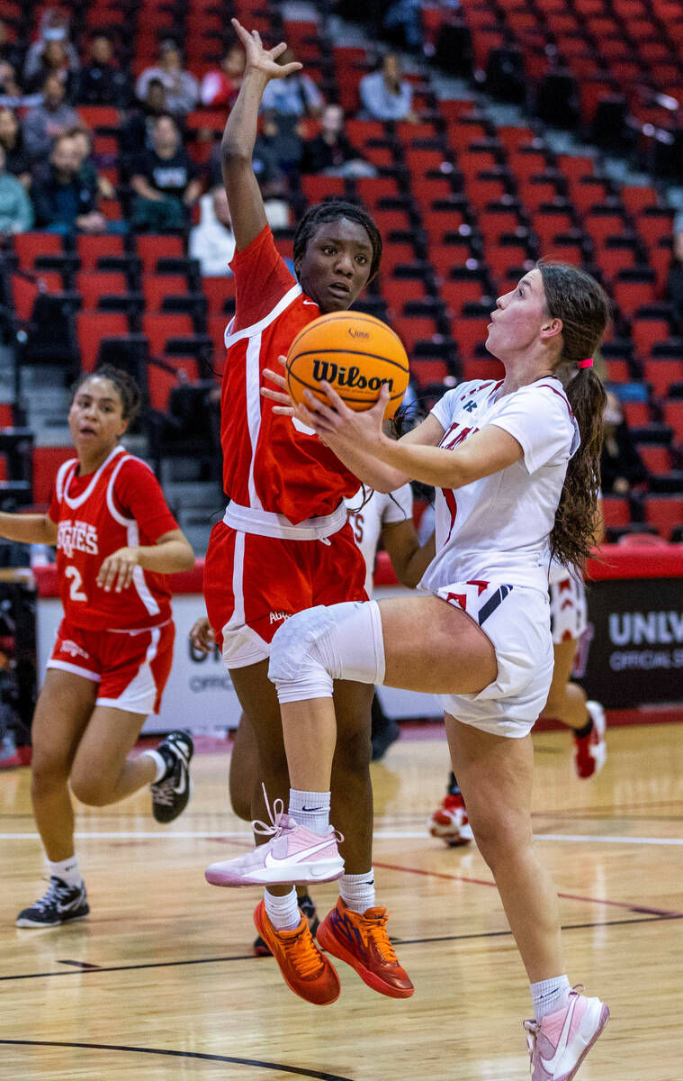 Las Vegas' Layla Faught (1) drives the lane against Arbor View's Gemani Abrams (30) during the ...