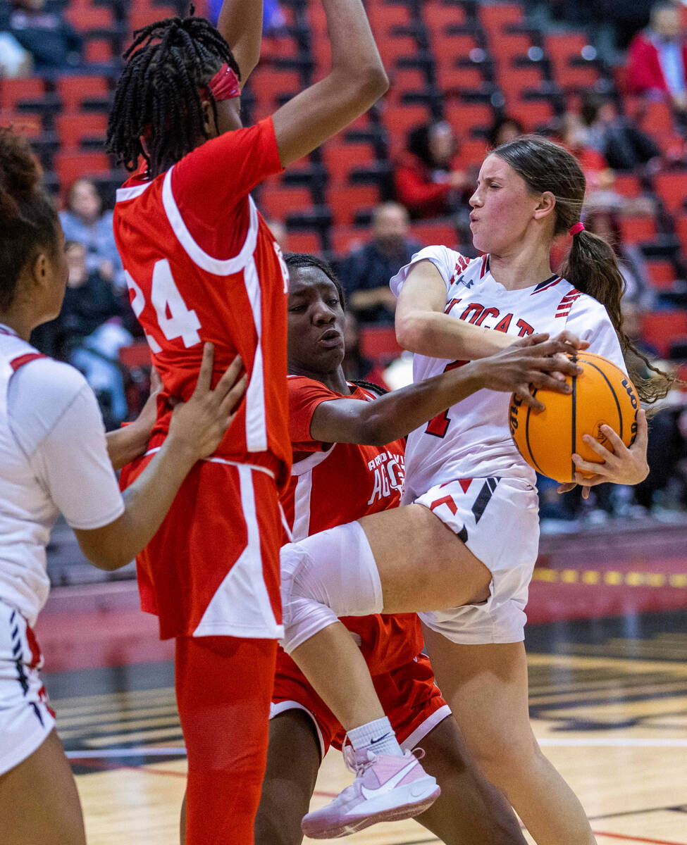 Las Vegas' Layla Faught (1) drives the lane and is fouled by Arbor View's Gemani Abrams (30) d ...