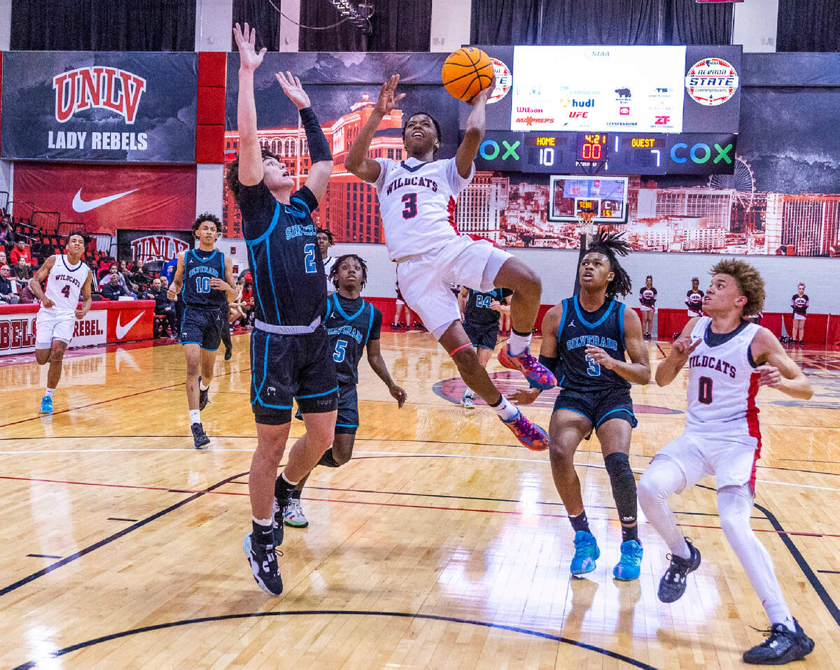 Las Vegas' Tayshaun Jackson (3) splits the defense of Silverado's Kollin Ngo (2) and teammate J ...