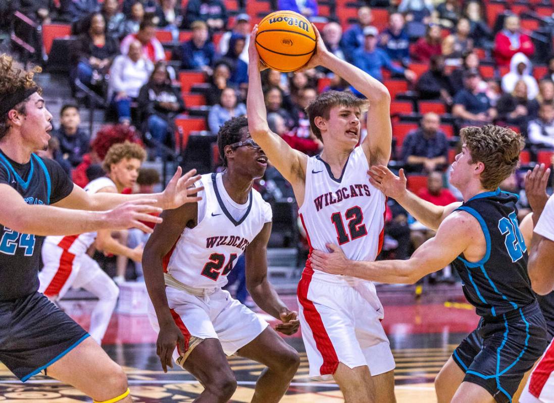 Las Vegas' Collin McCoy (12) looks to pass against Silverado's Luke Wohl (20) during the first ...
