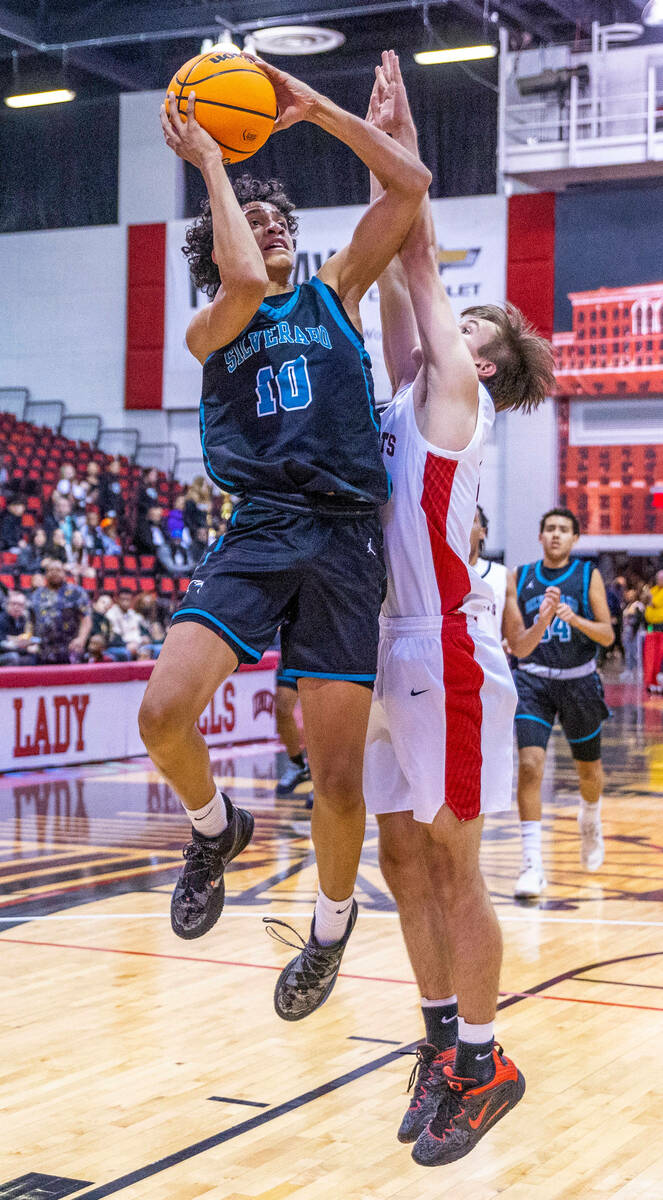 Silverado's Cyril Franklin, Jr. (10) goes up strong to the basket over tight defense by Las Veg ...