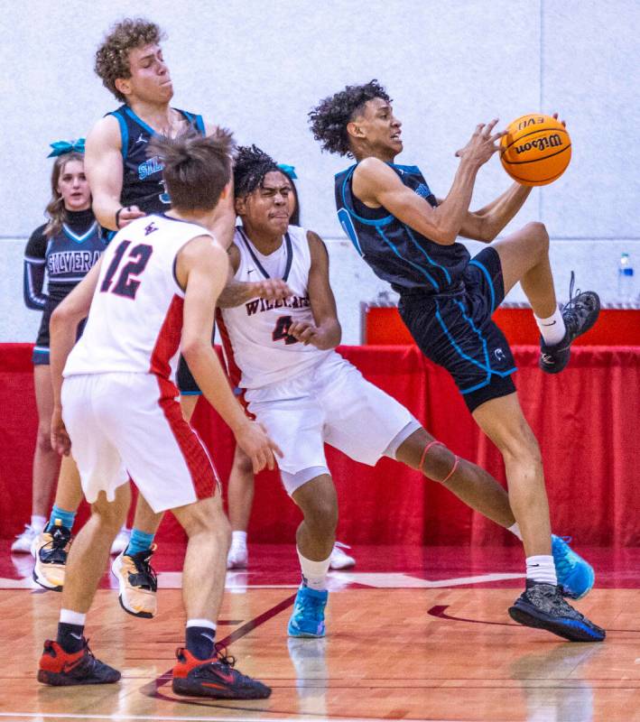 Silverado's Cyril Franklin, Jr. (10) fights to secure a rebound after fouled by Las Vegas' Marc ...