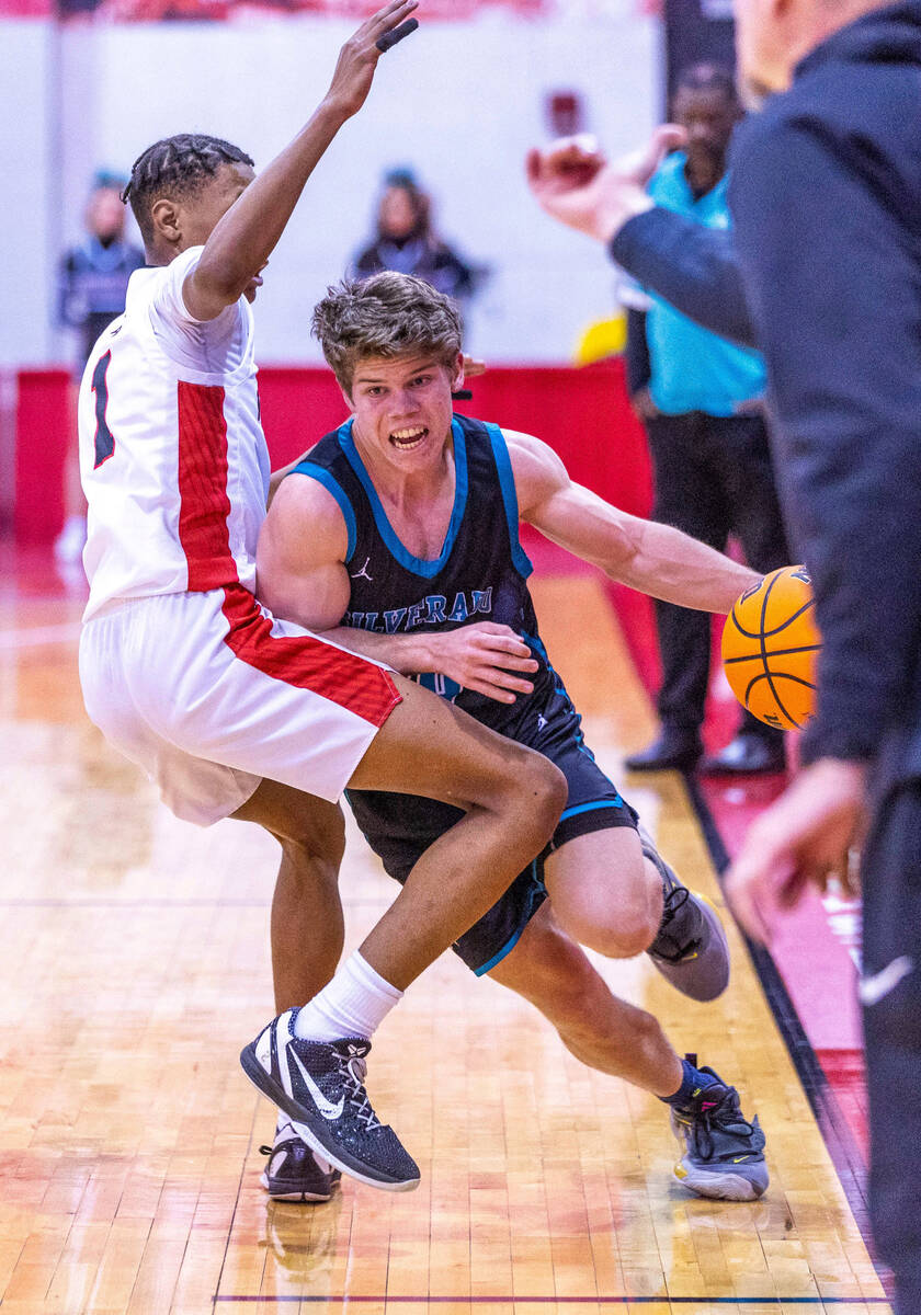 Silverado's Luke Wohl (20) fights to dribble around Las Vegas' Naseer Sims (1) during the first ...