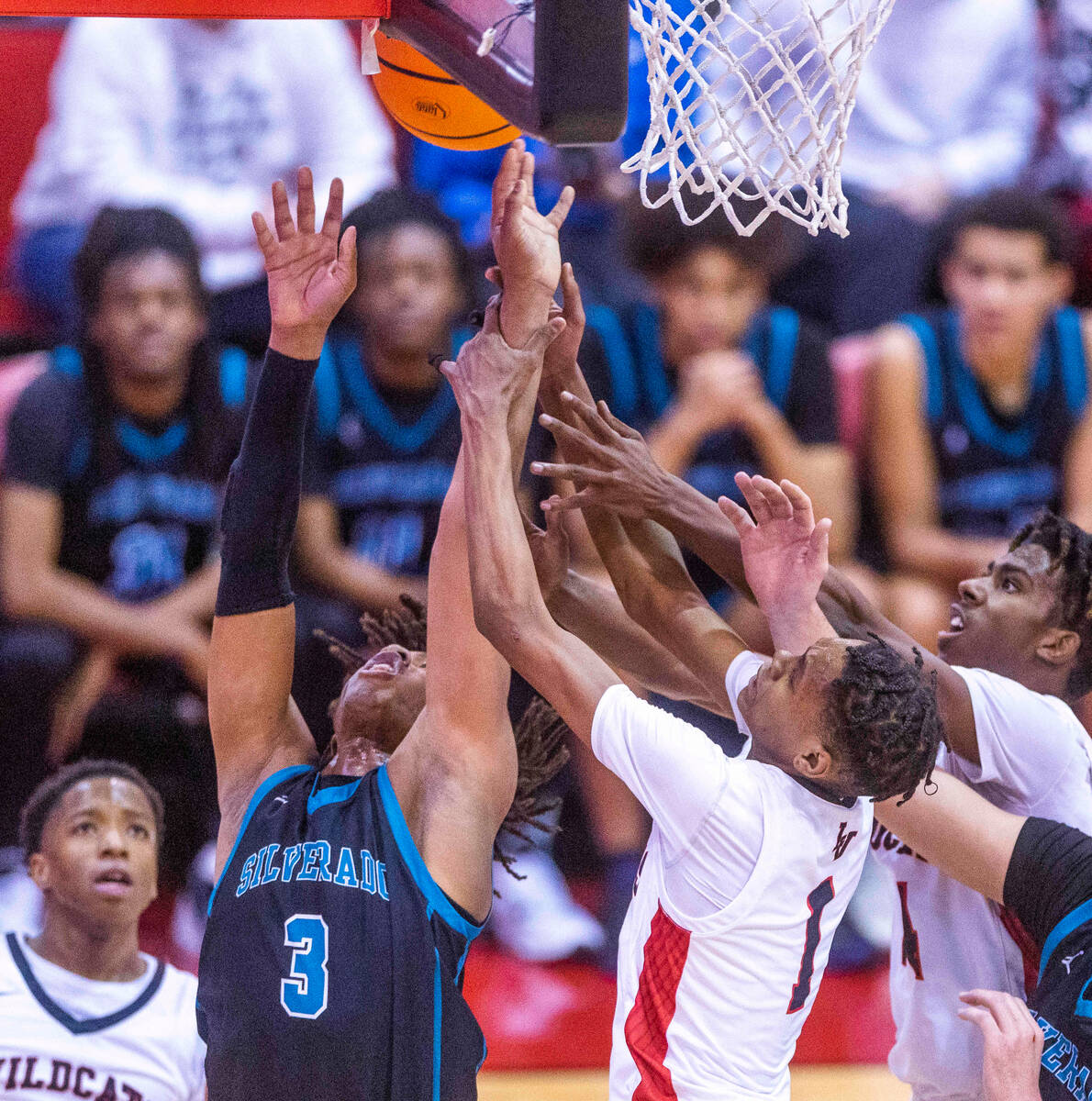 Silverado's Julius Robinson (3) is fouled while fighting for a rebound by Las Vegas' Naseer Sim ...