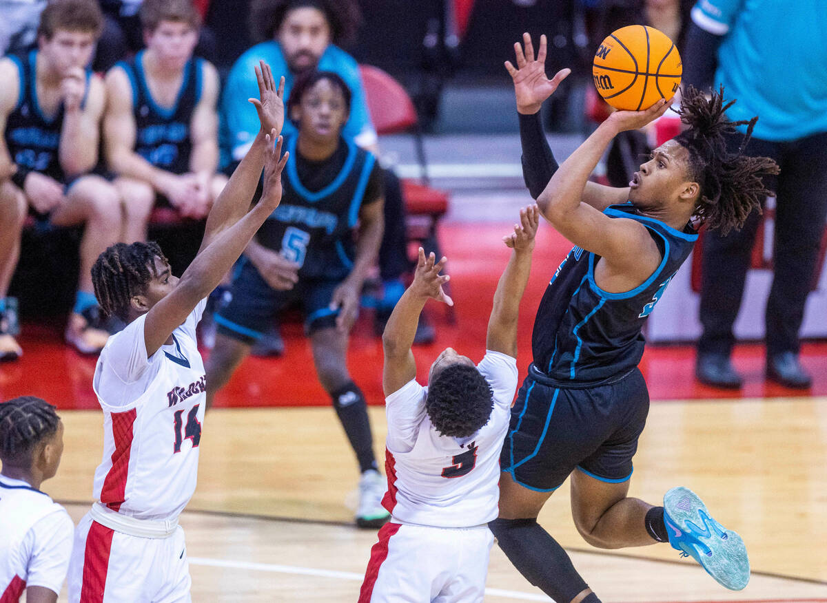 Silverado's Julius Robinson (3) elevates to get a shot off over Las Vegas' Tayshaun Jackson (3) ...