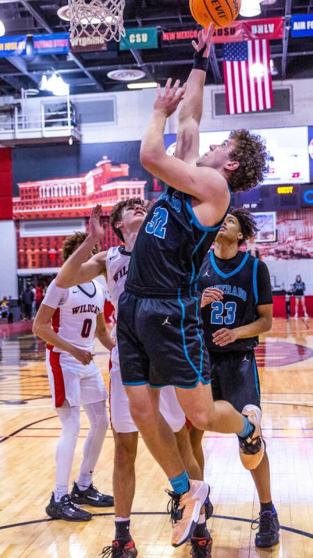 Silverado's Jake Wohl (32) goes back up with a shot attempt over Las Vegas' Collin McCoy (12) d ...