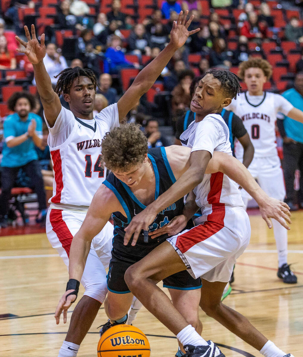 Silverado's Jake Wohl (32) is fouled while beating a double team of Las Vegas' Naseer Sims (1) ...
