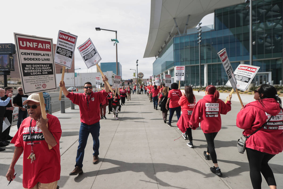 Culinary union members join a picket led by the Transport Workers Union Local 556, the union of ...