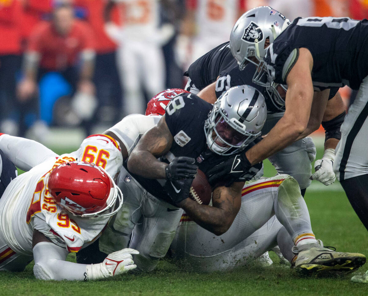 Raiders running back Josh Jacobs (28) is tackled by Kansas City Chiefs defensive tackle Khalen ...