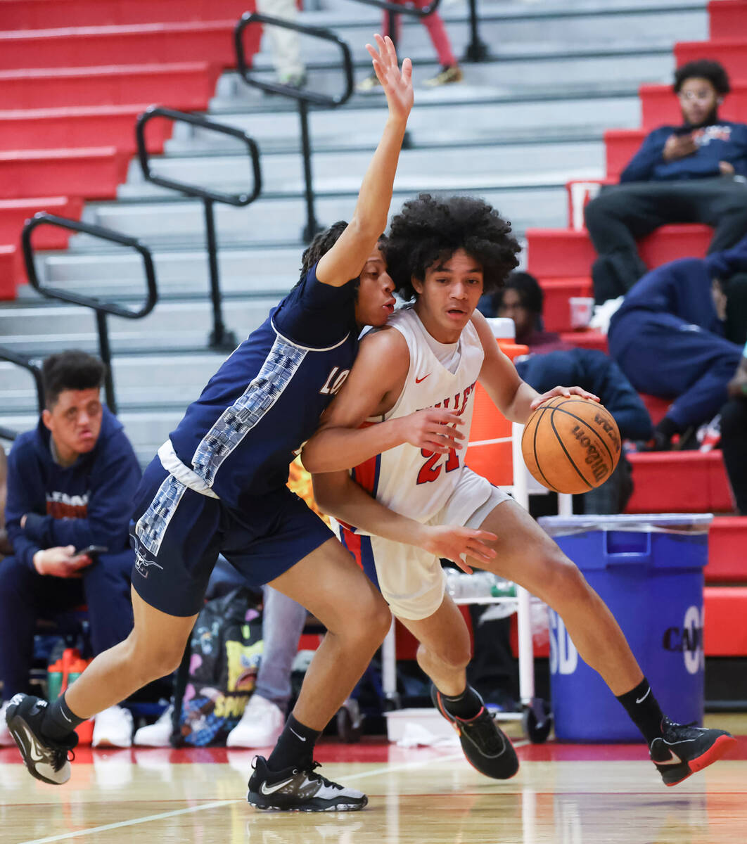 Valley's Kevan Wilkins (21) drives to the basket against Legacy's Ja'Merion Brass (11) during t ...