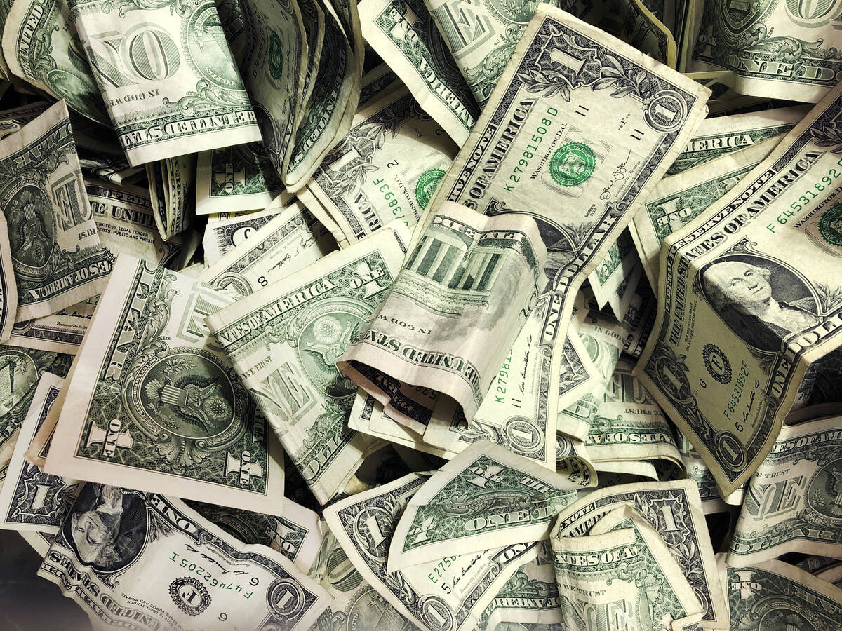 FILE - In this Jan. 21, 2020 file photo, dollar bills have been dropped into a tip jar at a car ...