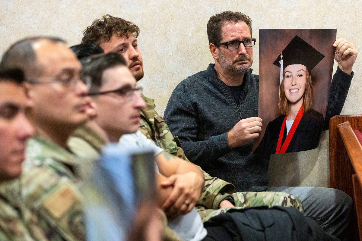 A family friend, who declined to give his name, holds a photograph of Brooklynn Fellure, a seni ...