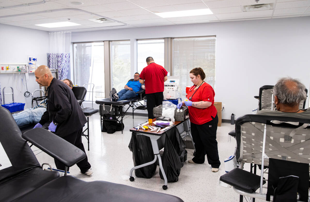 American Red Cross phlebotomist Abbi Mawyer, second from right, prepares to draw blood during a ...