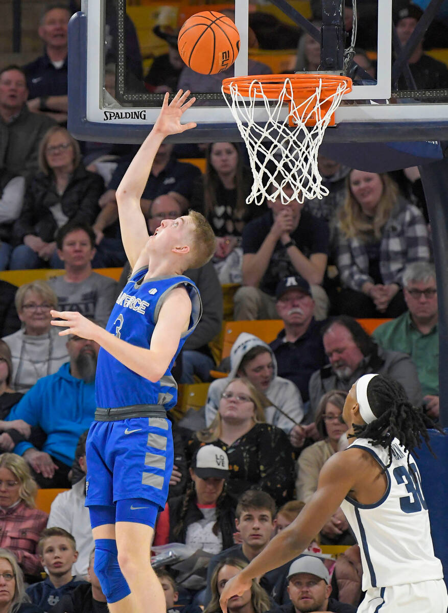 Air Force guard Jake Heidbreder (3) shoots the ball as Utah State forward Dan Akin defends duri ...