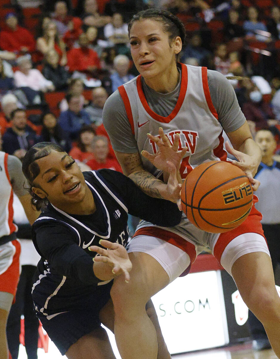 Utah State Aggies guard Isabella Tanedo (2), left, and UNLV Lady Rebels guard Essence Booker (2 ...