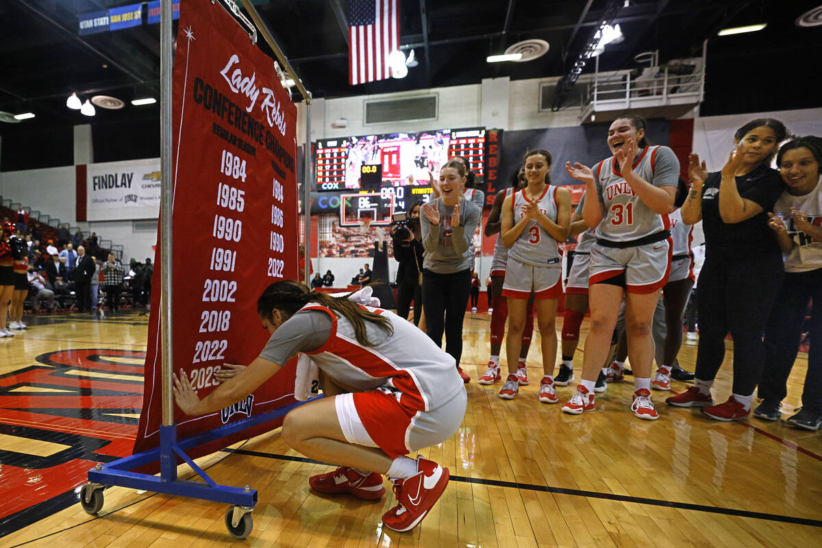 UNLV Lady Rebels guard Essence Booker (24) update the banner with a 2023 decal to recognize the ...