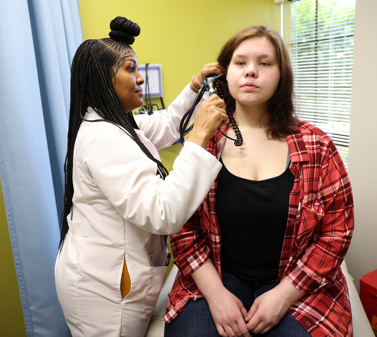 Lilnetra Grady, chief medical officer at FirstMed Health and Wellness Center, checks on patient ...