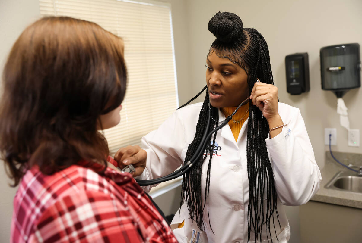 Lilnetra Grady, chief medical officer at FirstMed Health and Wellness Center, checks on patient ...