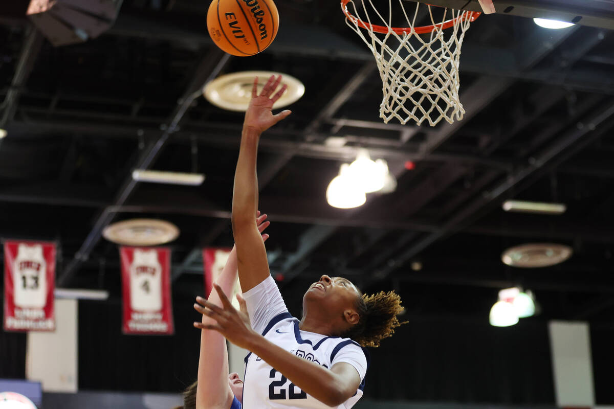 Centennial's Kaliyah Dillard (22) takes a shot under pressure from Reno's Kirsten Martin (10) d ...