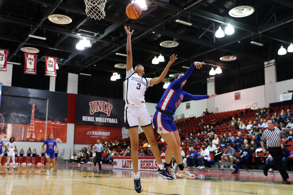 Centennial's Charlece Ohiaeri (3) shoots the ball as she is fouled by Reno's Adia Walker (25) d ...