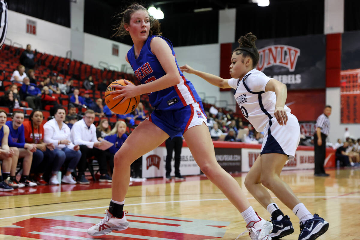Reno's Natalia Schettler (23) looks for an open pass under pressure from Centennial's Nivea Cam ...