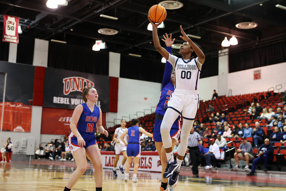 Centennial's Kaniya Boyd (00) takes a shot under pressure from Reno's Adia Walker (25) during a ...