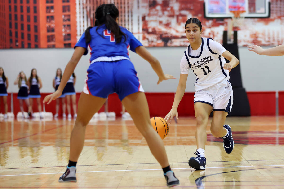 Centennial's Danae Powell (11) dribbles the ball toward Reno's Zoey Wilson (4) during a girls c ...