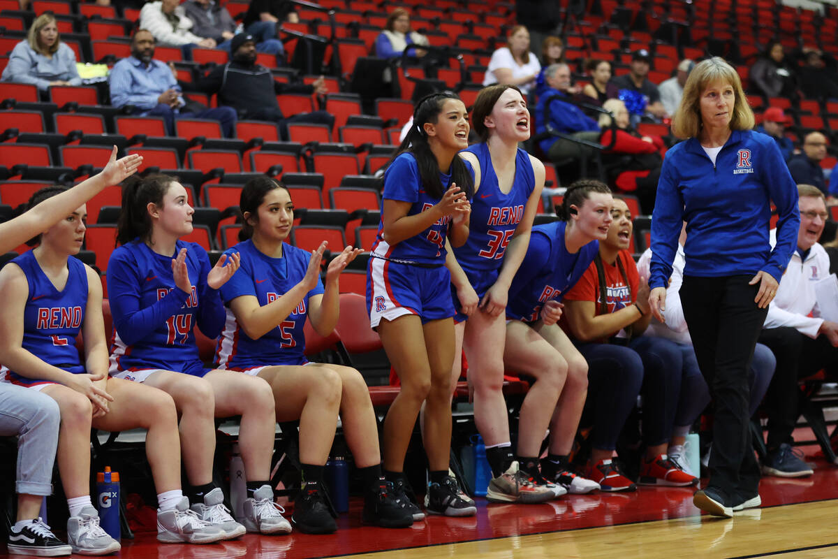 The Reno bench reacts a play during a girls class 5A state semifinal game against Centennial a ...