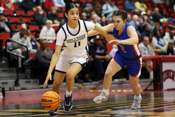 Centennial's Danae Powell (11) dribbles the ball past Reno's Tannis Jackin (2) during a girls c ...