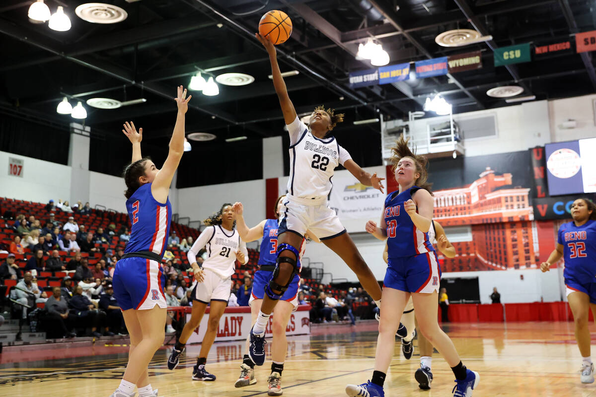 Centennial's Kaliyah Dillard (22) goes up for a shot against Reno during a girls class 5A state ...