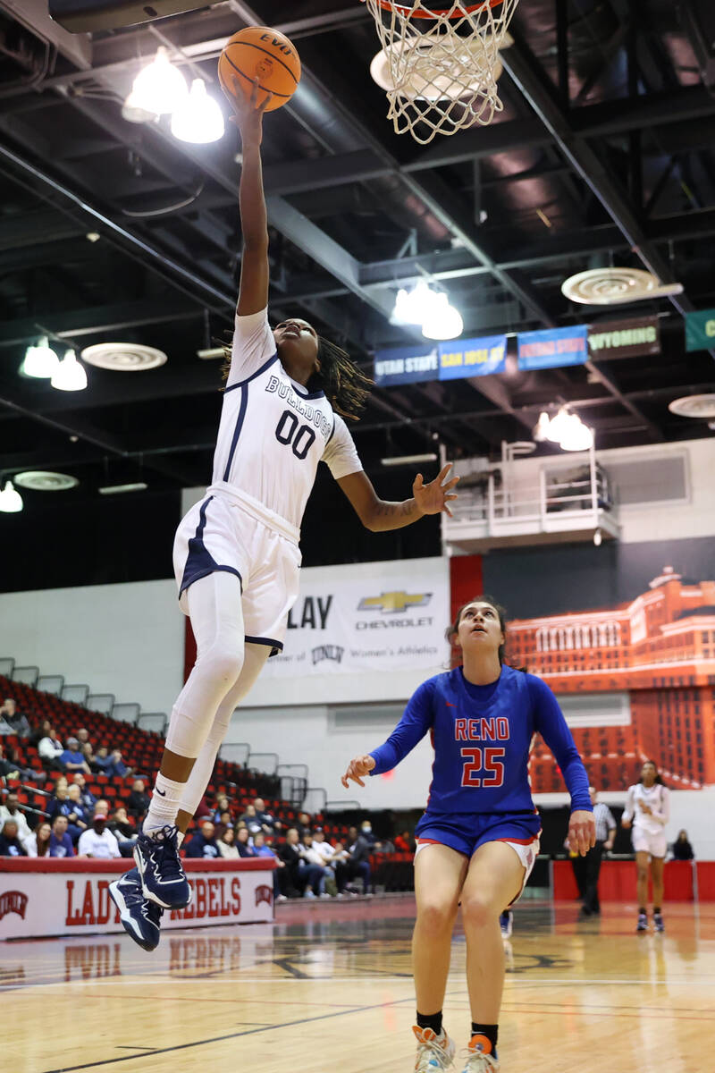 Centennial's Kaniya Boyd (00) goes up for a shot as Reno's Adia Walker (25) looks on during a g ...