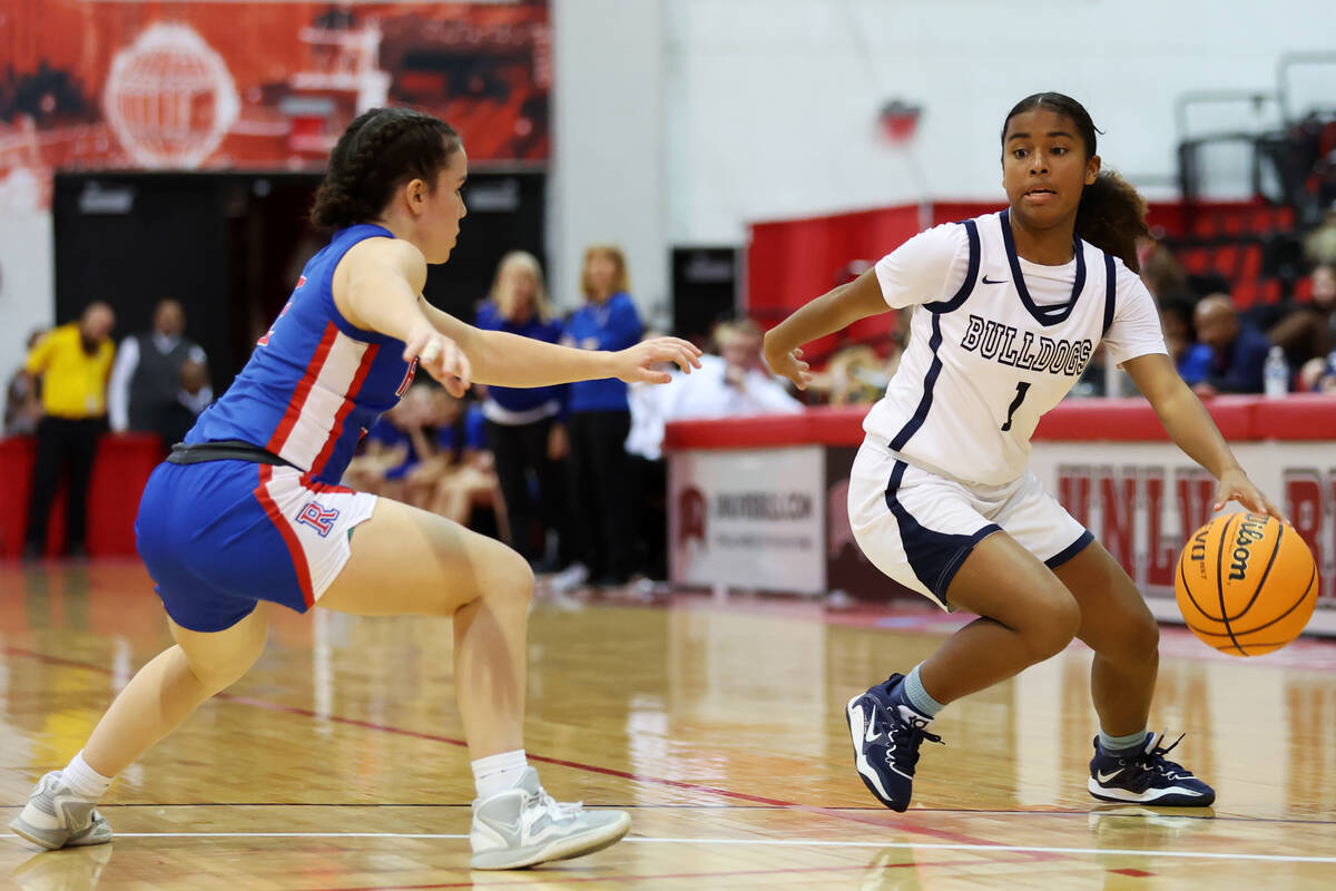 Centennial's Azaia Tatum (1) dribbles the ball past Reno's Tannis Jackin (2) during a girls cla ...