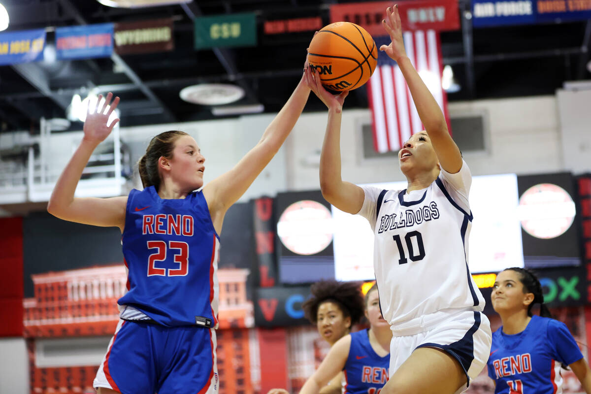 Centennial's Tayla Perkins (10) goes up for a shot under pressure from Reno's Natalia Schettler ...
