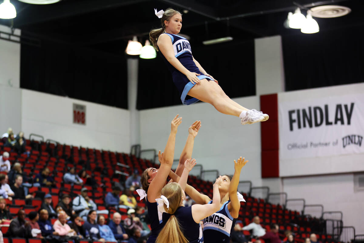 Cheerleaders perform during a girls class 5A state semifinal game between Centennial and Reno a ...