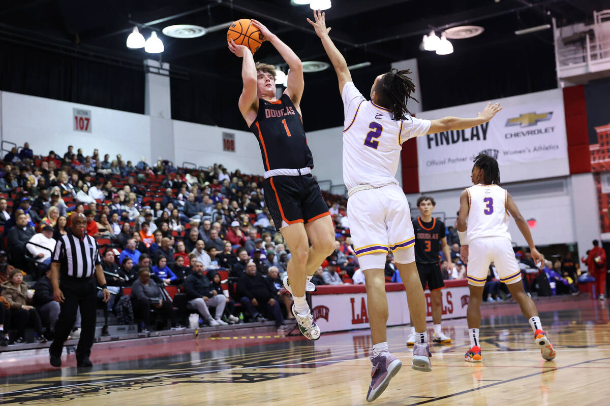 Douglas' Jac Reid (1) takes a shot under pressure from Durango's Mason Brown (2) during a boys ...