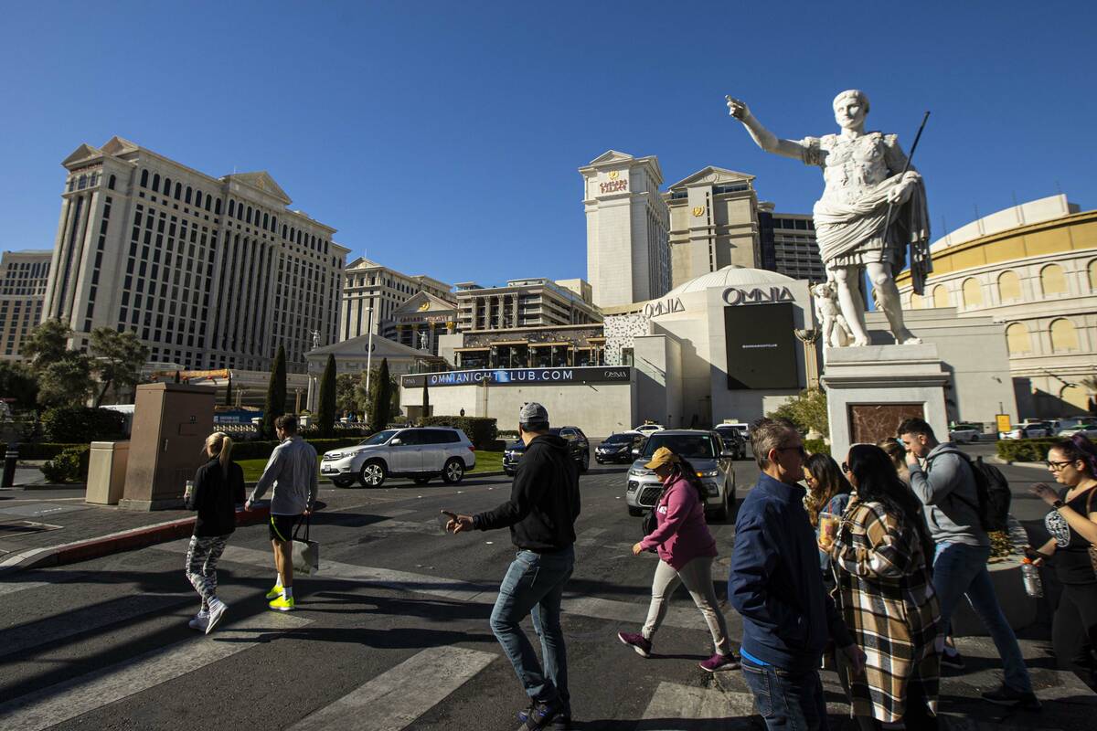 Pedestrians walk along the Las Vegas Strip outside of Caesars Palace on Thursday, Jan. 26, 2023 ...