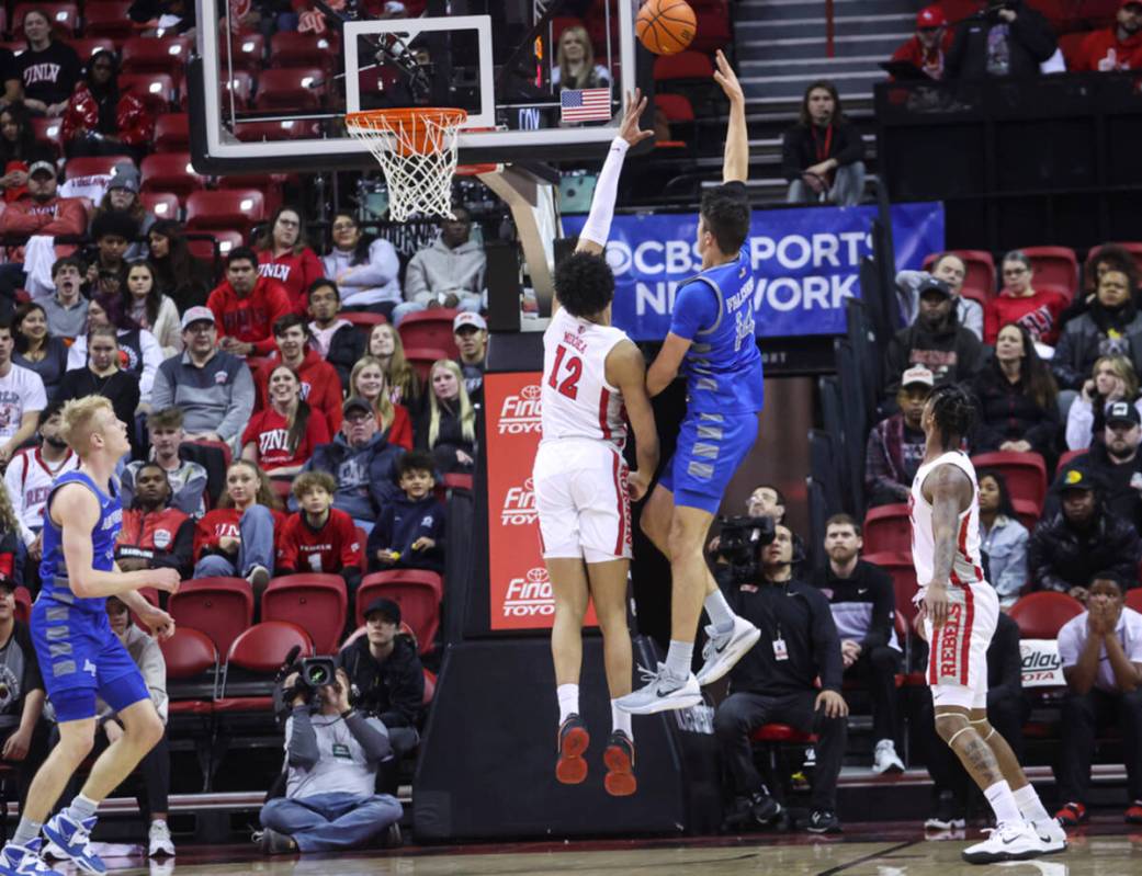 Air Force Falcons forward Beau Becker (14) lays up the ball as UNLV center David Muoka (12) def ...