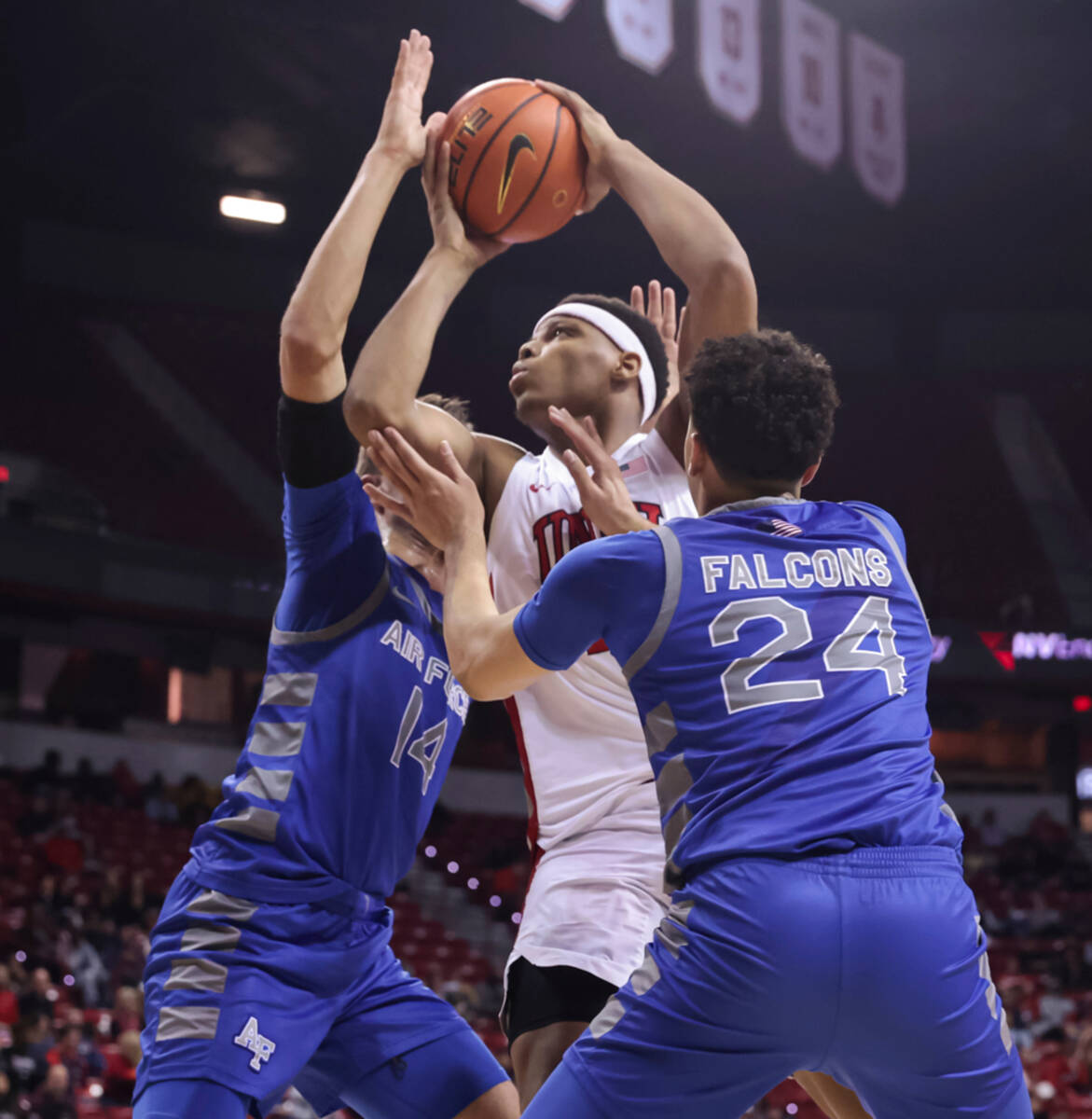 UNLV guard Keyshawn Hall, center, drives to the basket between Air Force Falcons forward Beau B ...