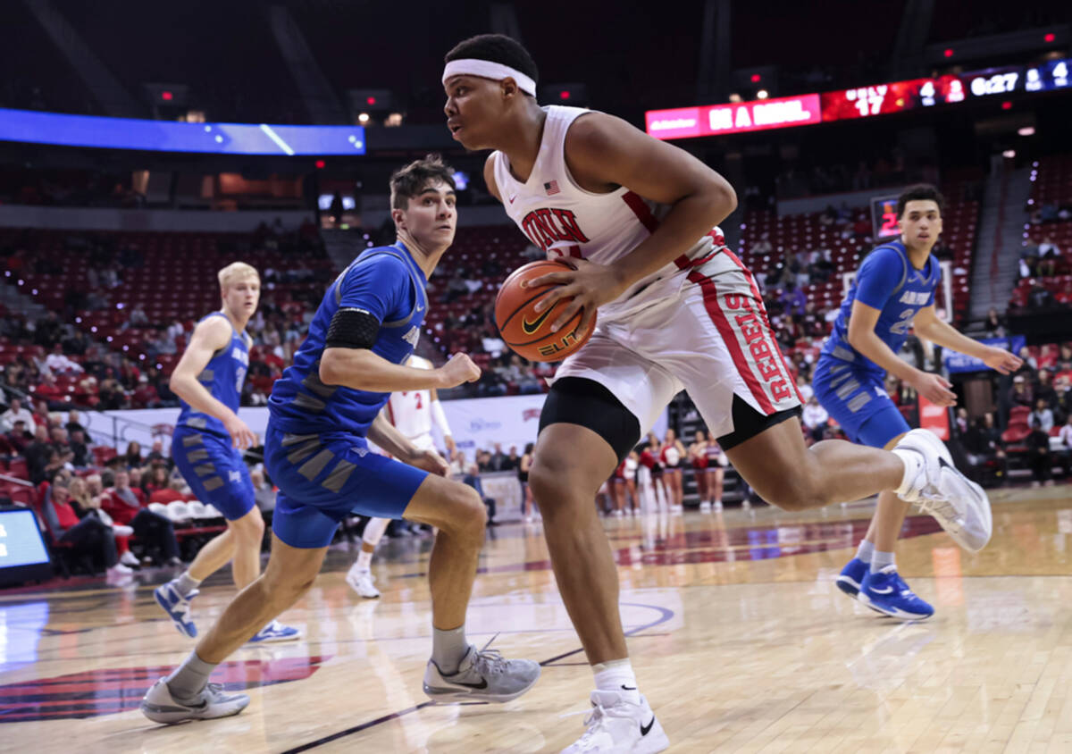 UNLV guard Keyshawn Hall, right, drives the ball around Air Force Falcons forward Beau Becker ( ...