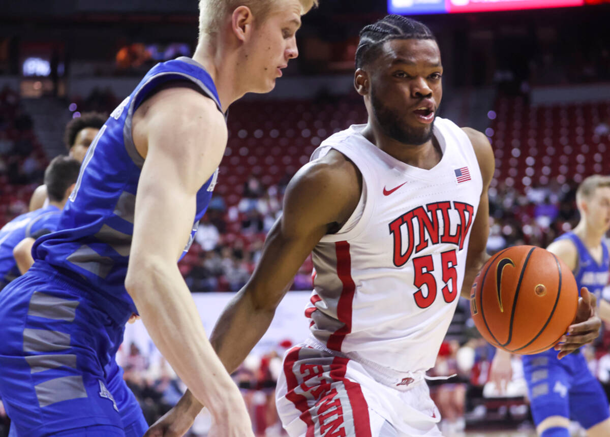 UNLV guard EJ Harkless (55) drives the ball under pressure from Air Force Falcons forward Rytis ...