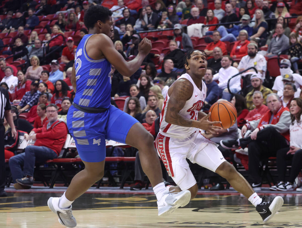 UNLV guard Jackie Johnson III (24) drives to the basket past Air Force Falcons guard Marcell Mc ...