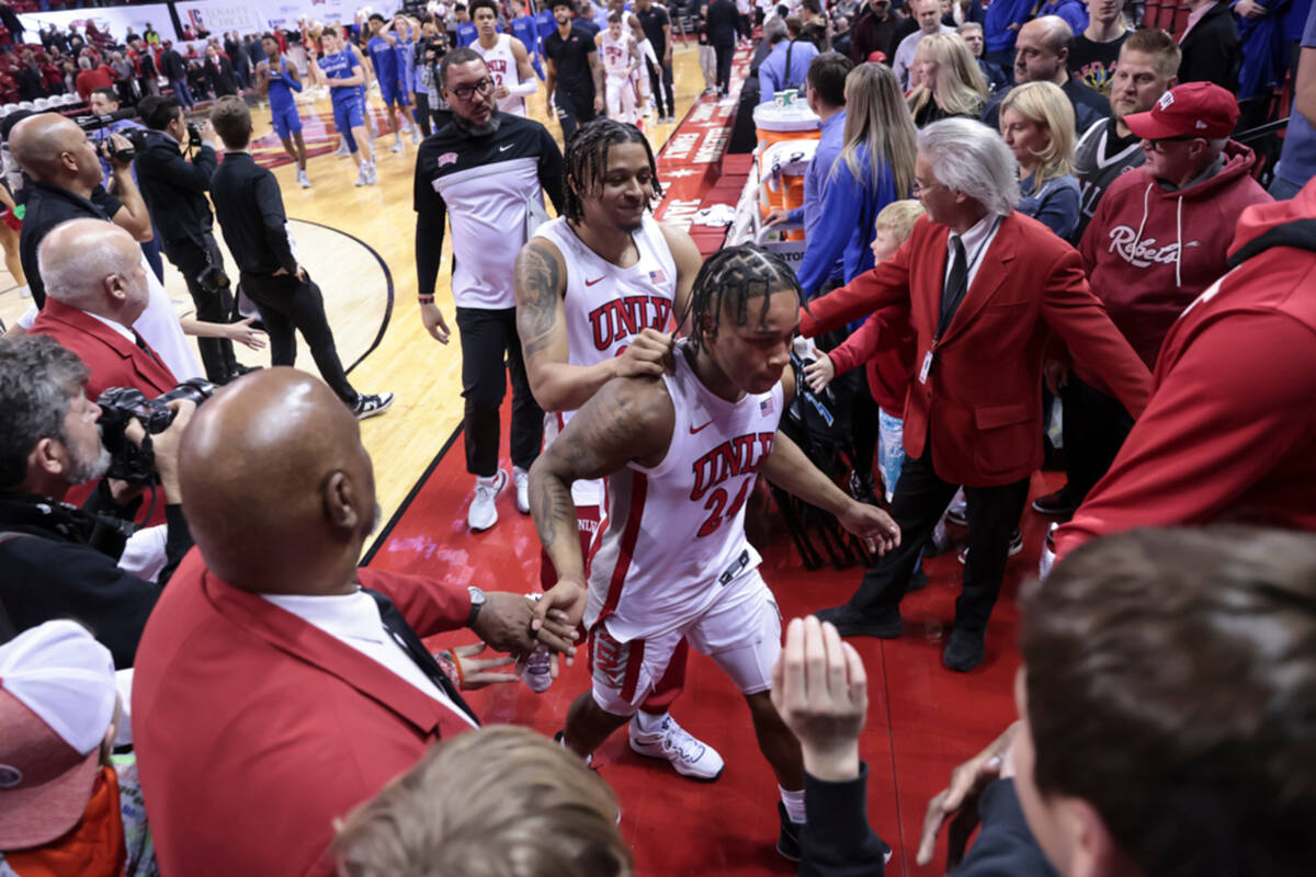 UNLV guard Jackie Johnson III (24) and UNLV guard Cameron Burist (34) head off the court after ...