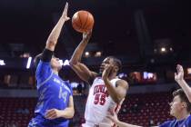 UNLV guard EJ Harkless (55) tries to shoot around Air Force Falcons forward Beau Becker (14) du ...