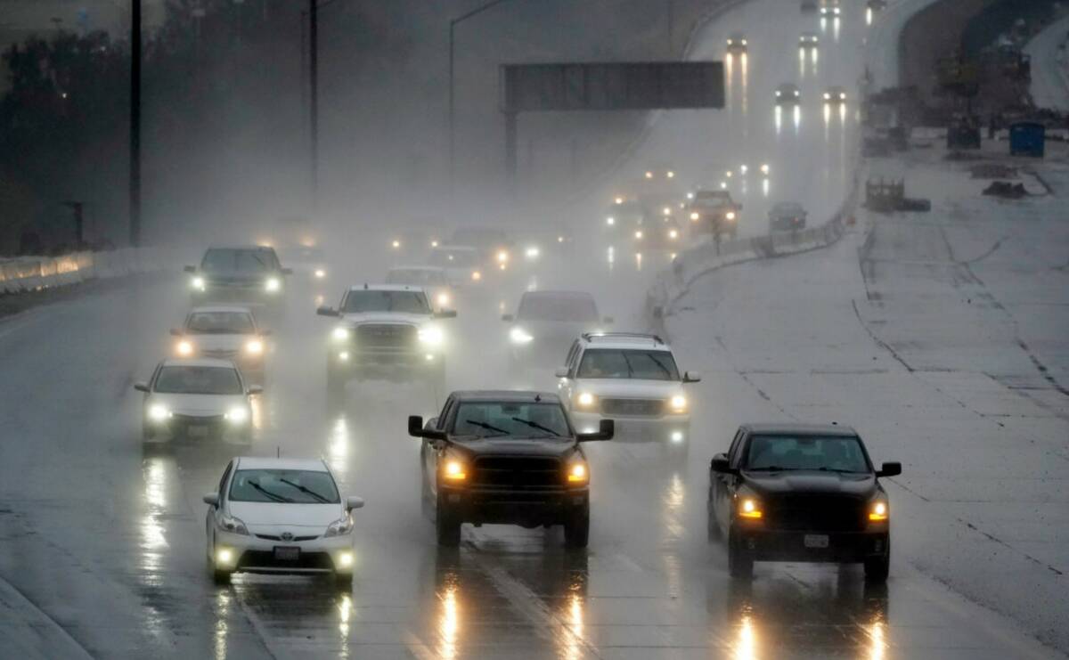 Traffic makes its way along interstate 5 during a rainstorm Friday, Feb. 24, 2023, in Santa Cla ...