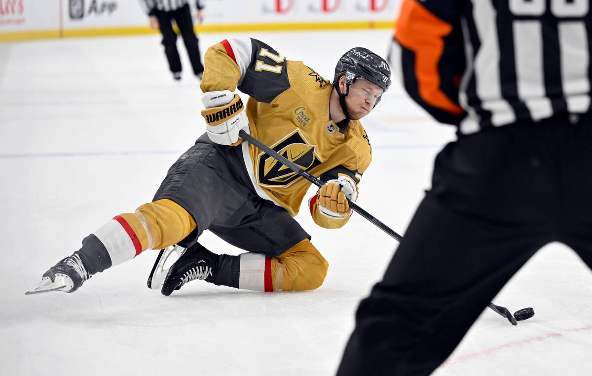 Vegas Golden Knights center William Karlsson (71) slides on the ice as he passes the puck again ...