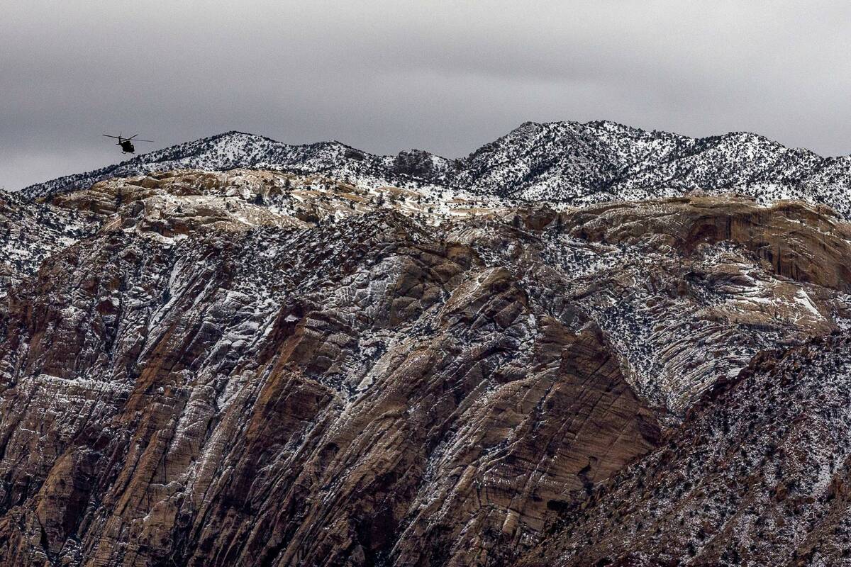 A helicopter flys over the Red Rock Canyon National Conservation Area on Friday, Feb. 24, 2023, ...