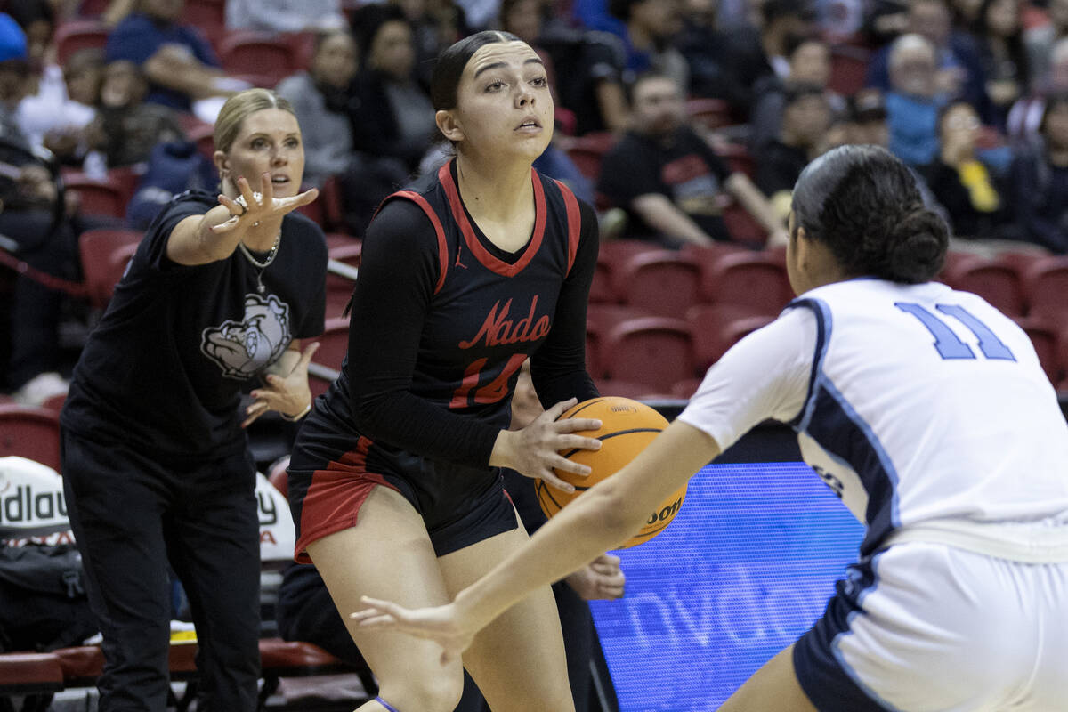 Coronado’s Kaylee Walters (14) looks to pass by Centennial’s Danae Powell (11) du ...